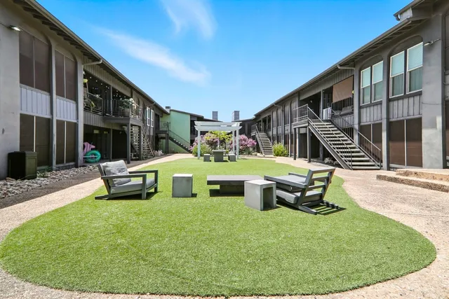 a house view with a sitting space fire pit and outdoor space