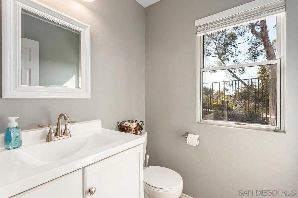1501 Promontory Ridge Way Vista, CA 92081 - Photo 13 of 22 a bathroom with a sink a toilet and a window