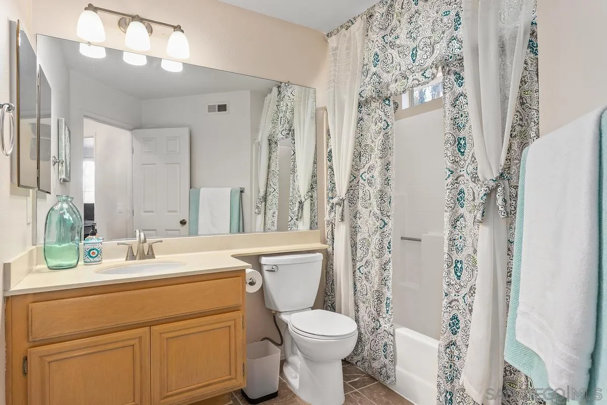 1501 Promontory Ridge Way Vista, CA 92081 - Photo 14 of 22 a bathroom with a sink toilet and shower