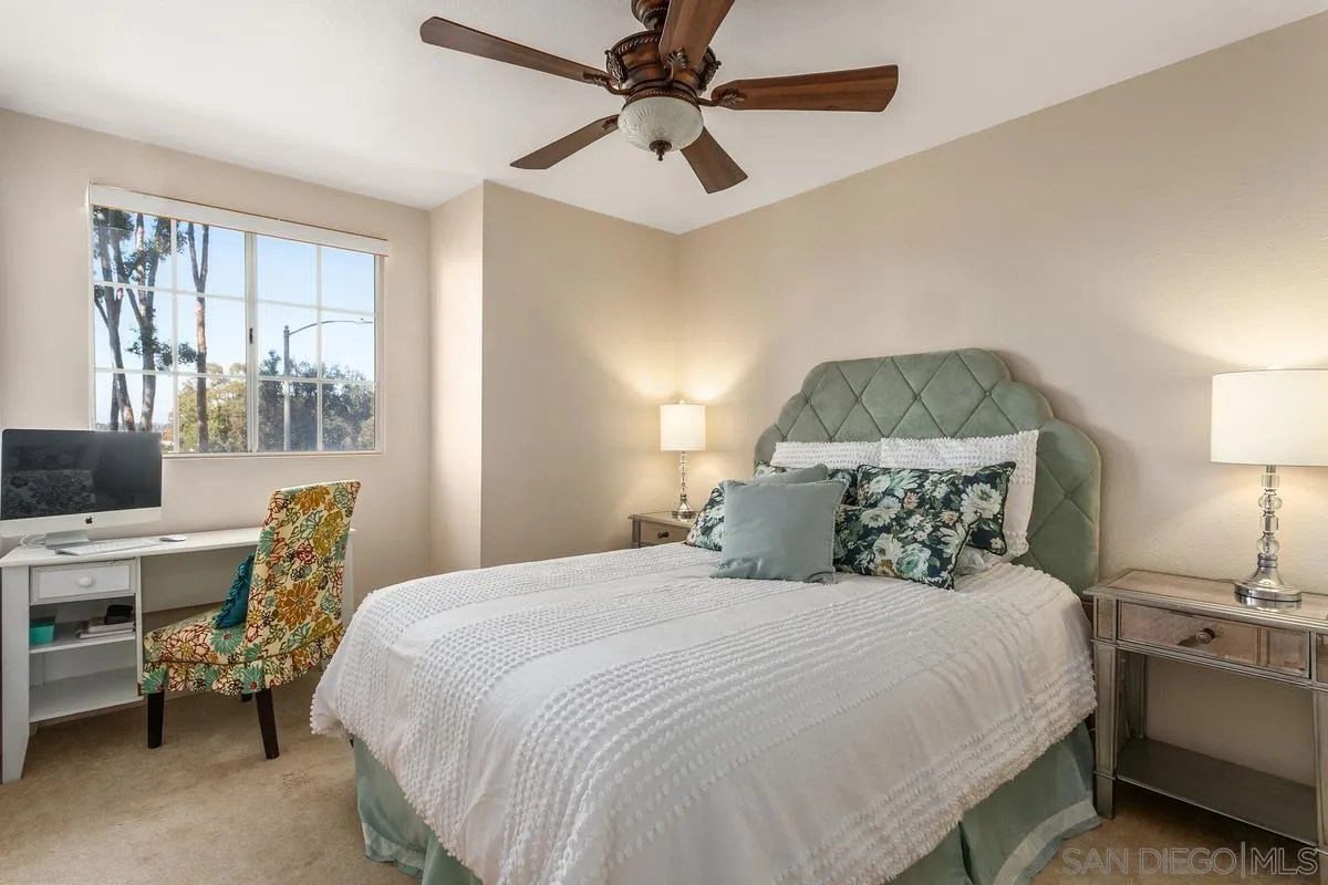 1501 Promontory Ridge Way Vista, CA 92081 - Photo 15 of 22 a bedroom with a bed a desk and chair with chandelier