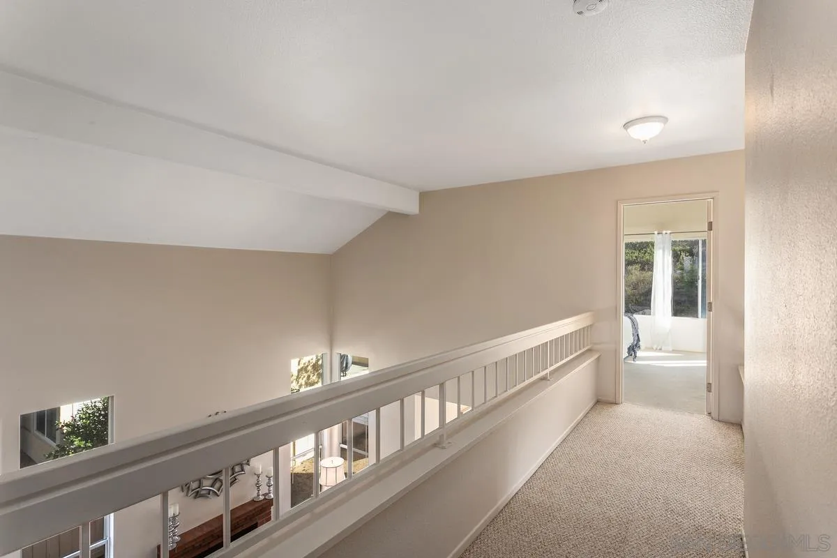 1501 Promontory Ridge Way Vista, CA 92081 - Photo 17 of 22 a hallway with white walls and stairs