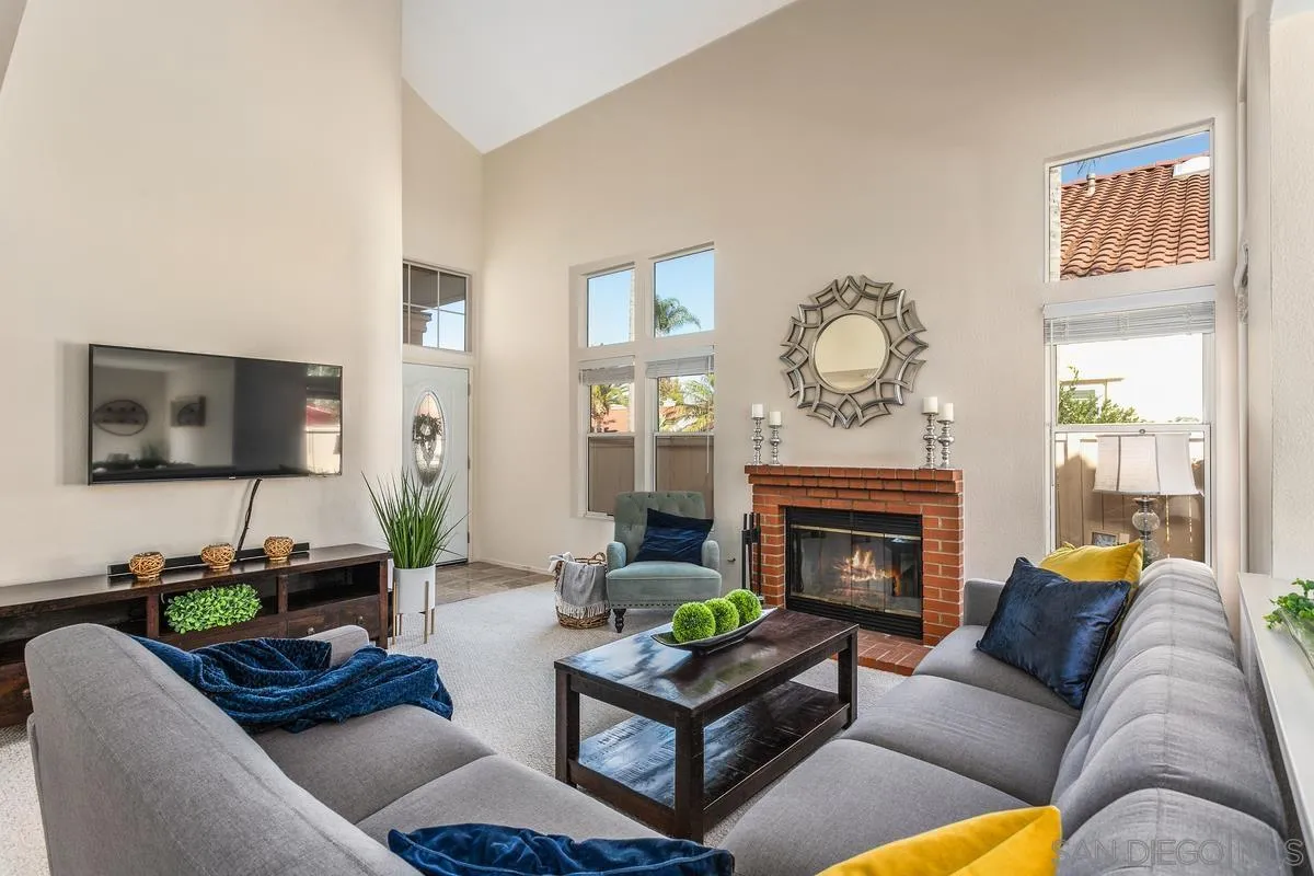 1501 Promontory Ridge Way Vista, CA 92081 - Photo 4 of 22 a living room with furniture a flat screen tv and a fireplace