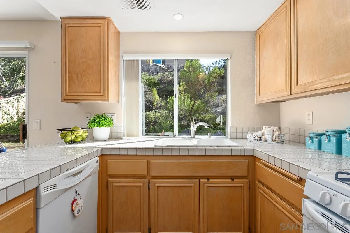 1501 Promontory Ridge Way Vista, CA 92081 - Photo 9 of 22 a kitchen with granite countertop a sink and a window