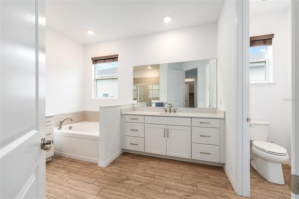 6488 Southwest 78th Court Ocala, FL 34474 - Photo 15 of 40 a bathroom with a sink a toilet and a large mirror