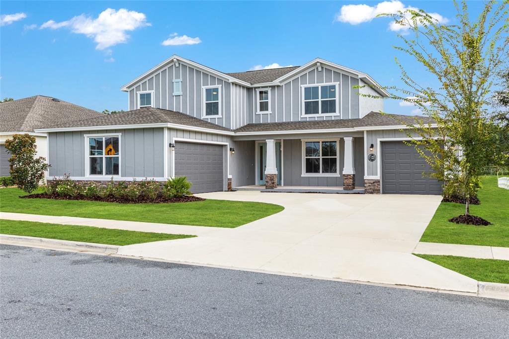 6488 Southwest 78th Court Ocala, FL 34474 - Photo 2 of 40 front view of a house next to a yard