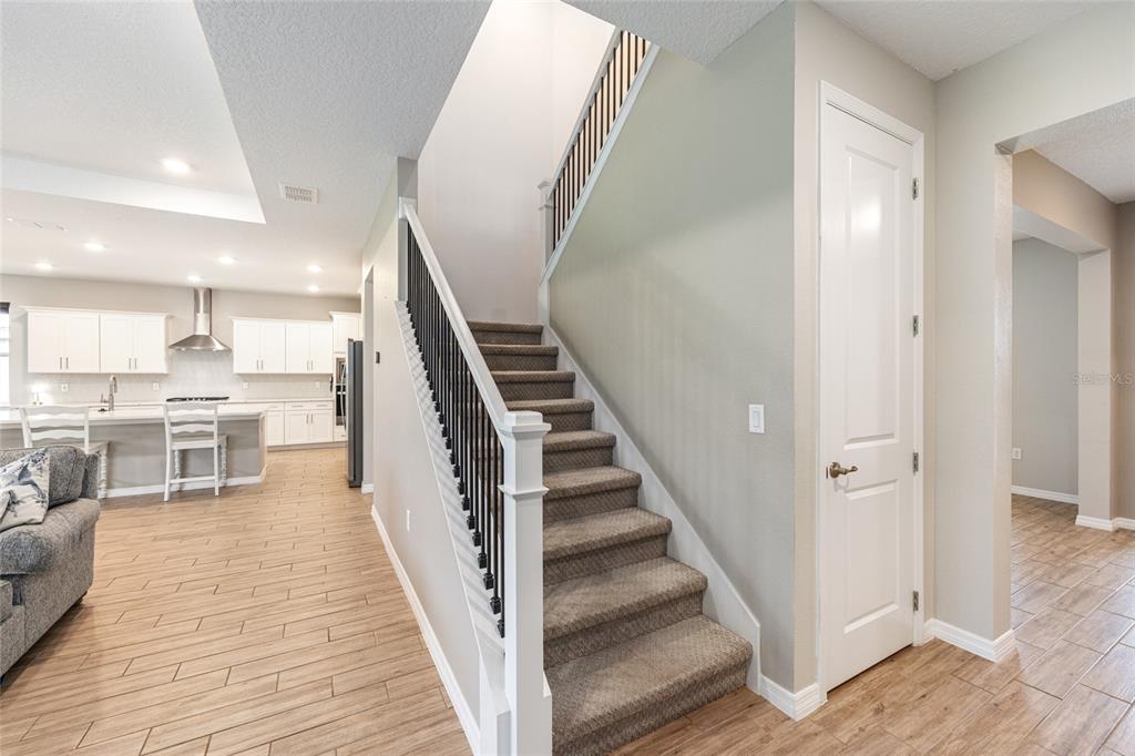 6488 Southwest 78th Court Ocala, FL 34474 - Photo 22 of 40 a view of a kitchen with wooden floor and stairs