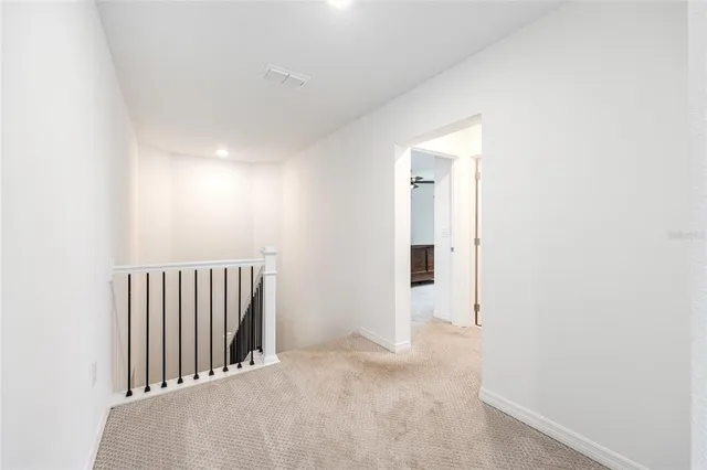 a spacious bedroom with a bed window and a flat screen tv