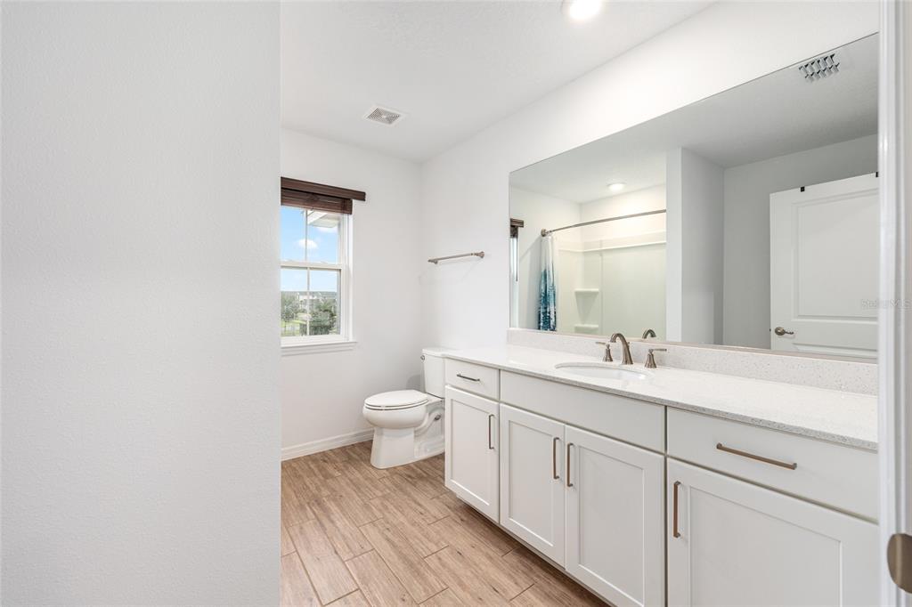 6488 Southwest 78th Court Ocala, FL 34474 - Photo 25 of 40 a bathroom with a toilet a sink and mirror