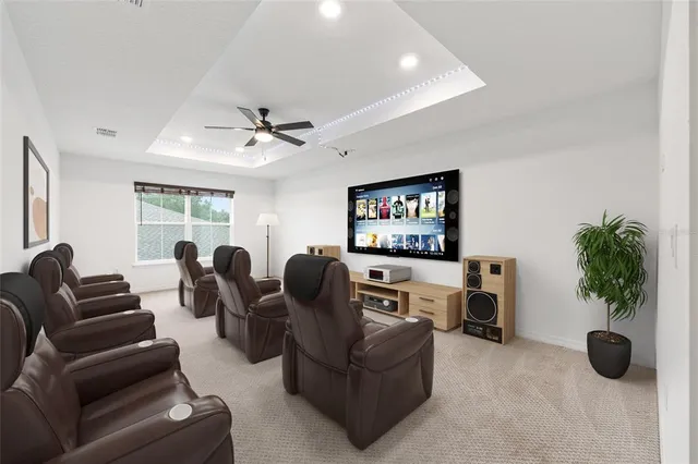 an empty room with windows and ceiling fan