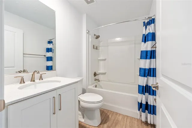 a bathroom with a sink a toilet and a large mirror