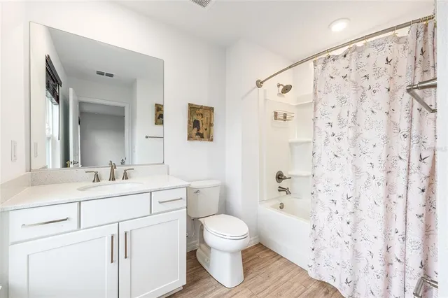 a view of an empty room with a floor to ceiling window and an outdoor view