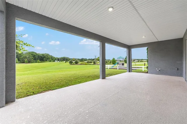 a front view of a house with a yard and potted plants