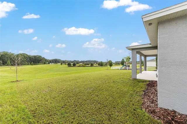 an aerial view of a house with a garden and swimming pool