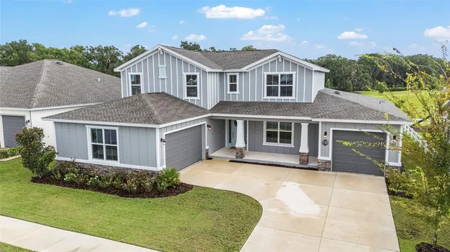 a view of a tennis ground with a table and chairs