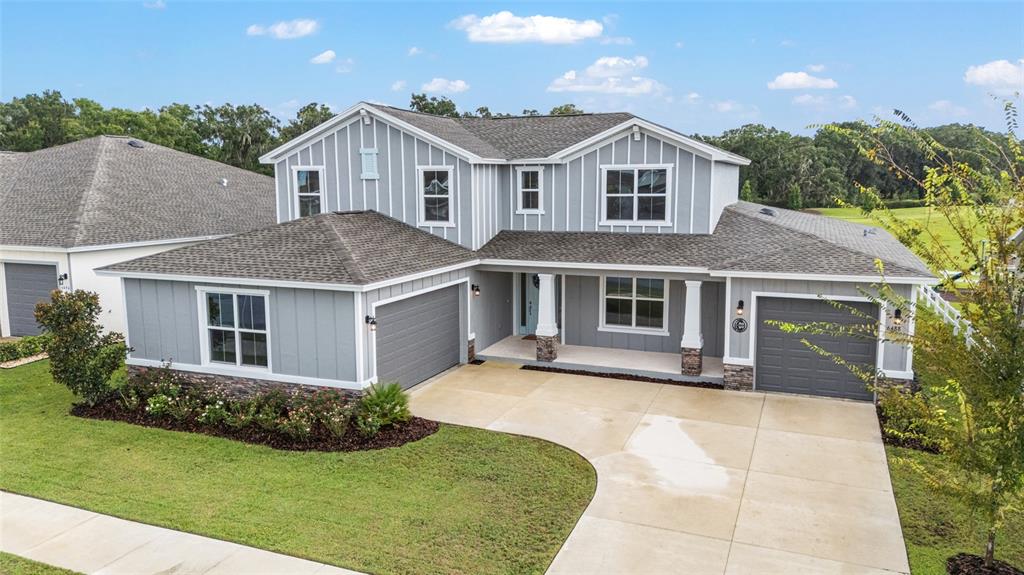 6488 Southwest 78th Court Ocala, FL 34474 - Photo 36 of 40 a front view of a house with a yard and potted plants