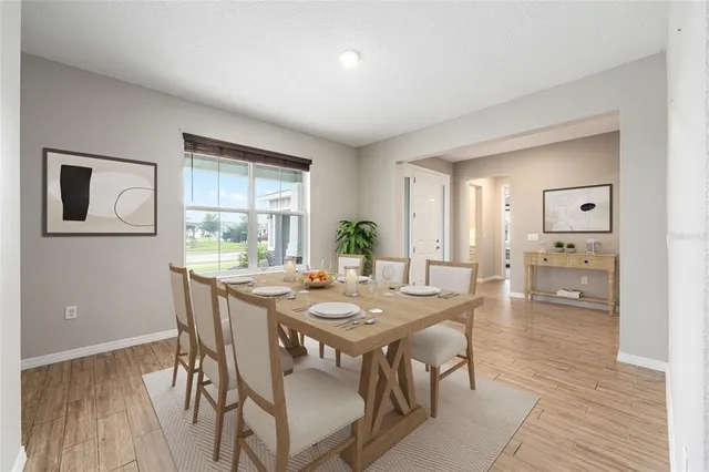 a view of a dining room with furniture and wooden floor