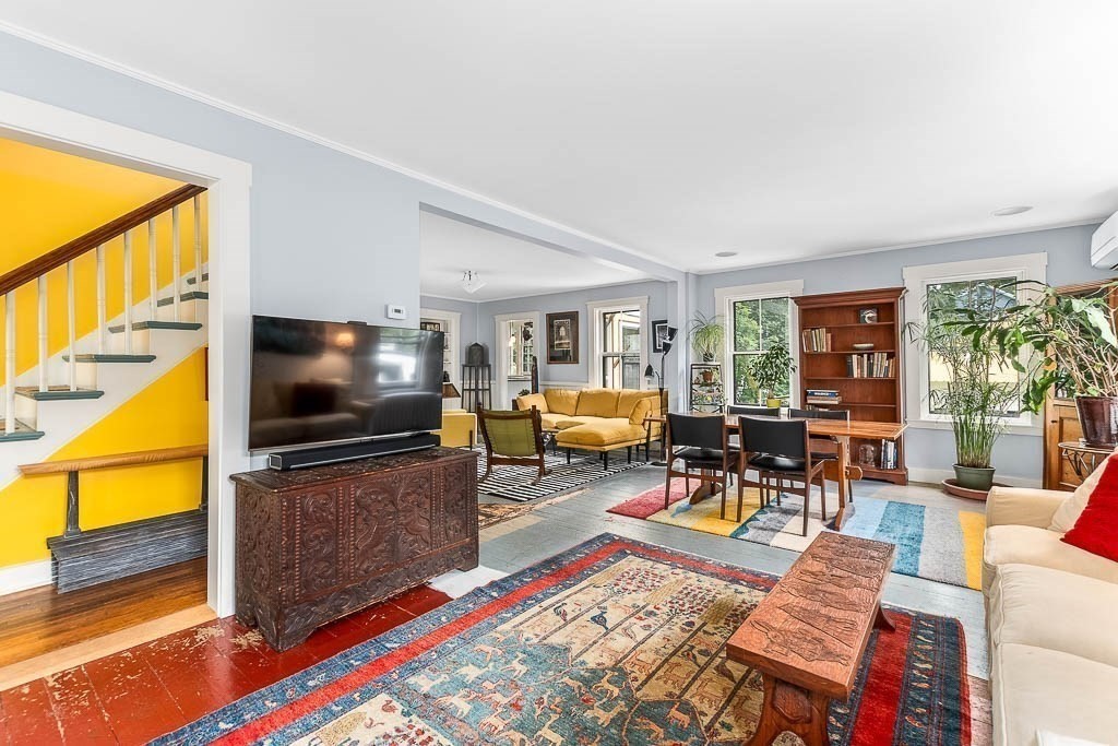 56 Clark Street Dedham, MA 02026 - Photo 11 of 42 a living room with furniture a flat screen tv and floor to ceiling window