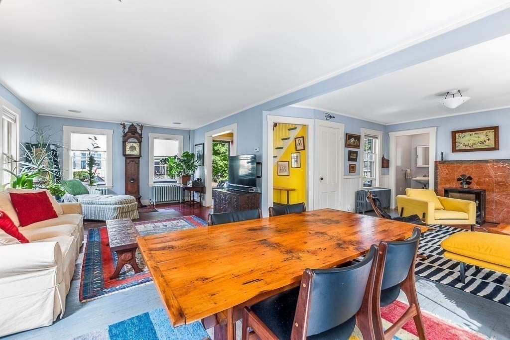 56 Clark Street Dedham, MA 02026 - Photo 13 of 42 a living room with furniture a flat screen tv and a table