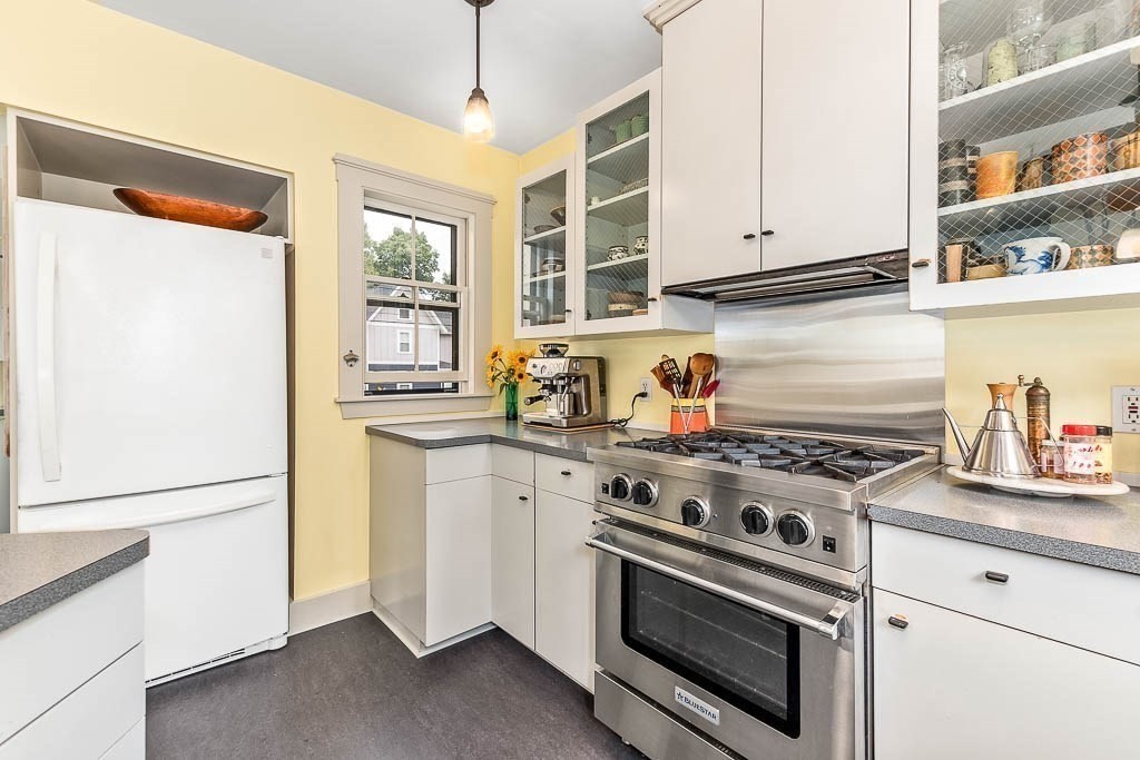 56 Clark Street Dedham, MA 02026 - Photo 17 of 42 a kitchen with stainless steel appliances granite countertop a stove and a refrigerator