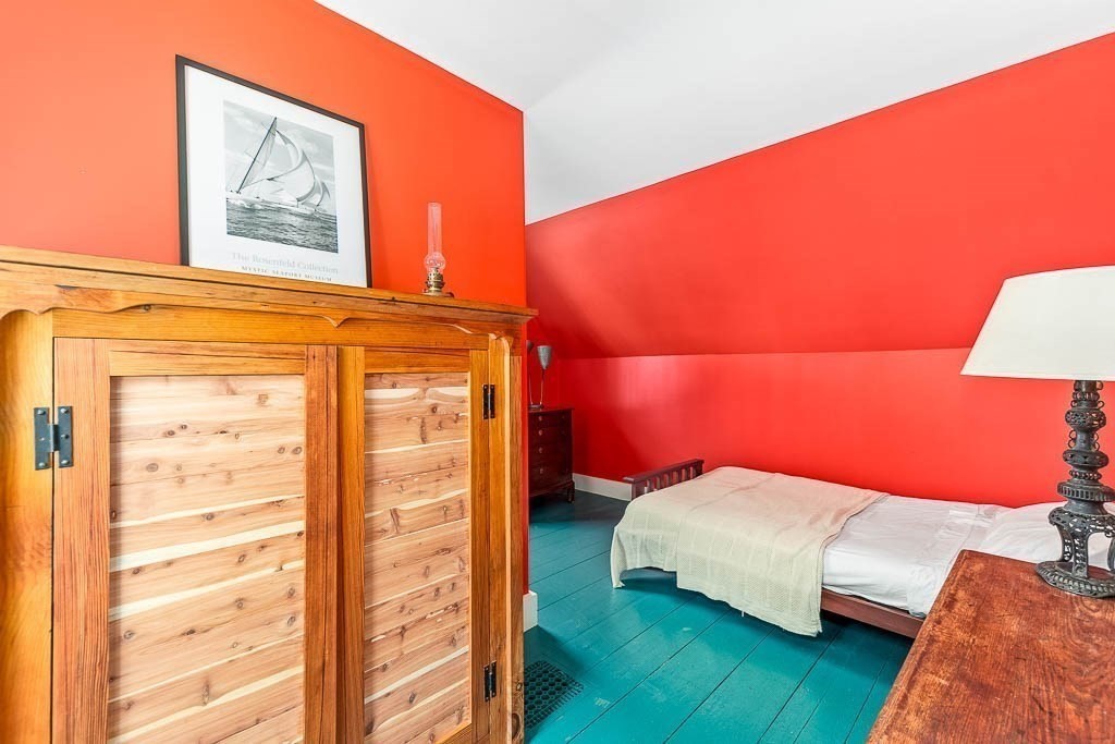 56 Clark Street Dedham, MA 02026 - Photo 31 of 42 a bedroom with a bed and a night stand