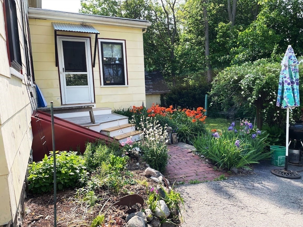 56 Clark Street Dedham, MA 02026 - Photo 34 of 42 a house with a flower garden