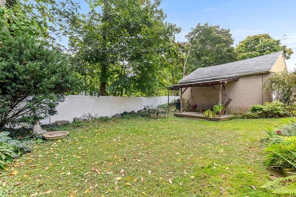 56 Clark Street Dedham, MA 02026 - Photo 35 of 42 a backyard of a house with plants and trees