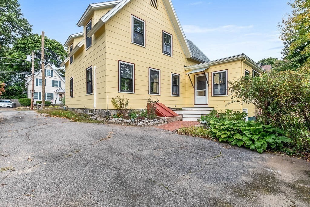 56 Clark Street Dedham, MA 02026 - Photo 39 of 42 a front view of a house with garden