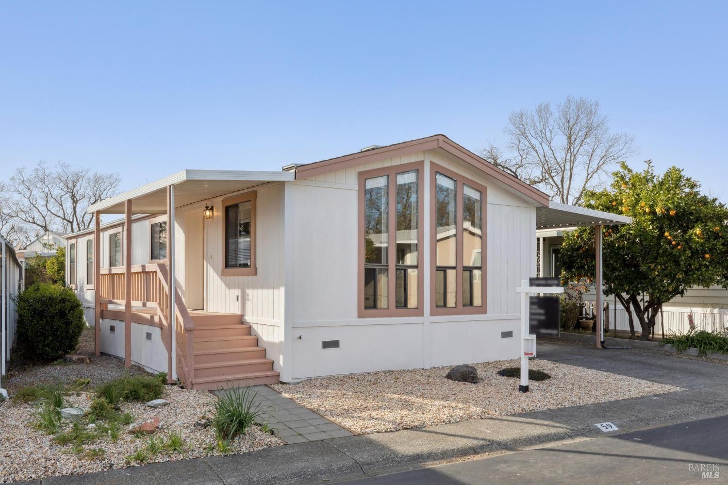 a front view of a house with a garden