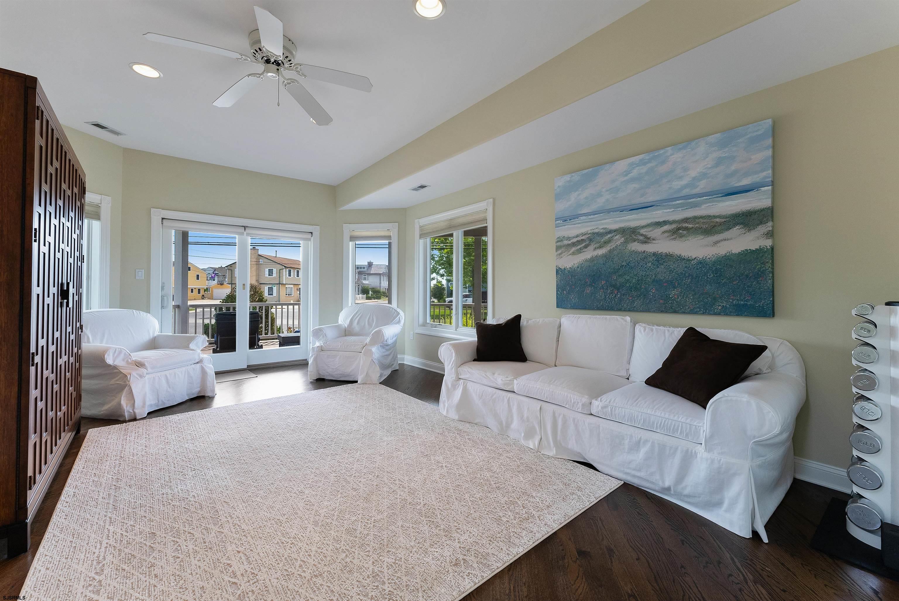 11901 2nd Avenue Stone Harbor, NJ 08247 - Photo 12 of 40 a living room with furniture large window and a flat screen tv