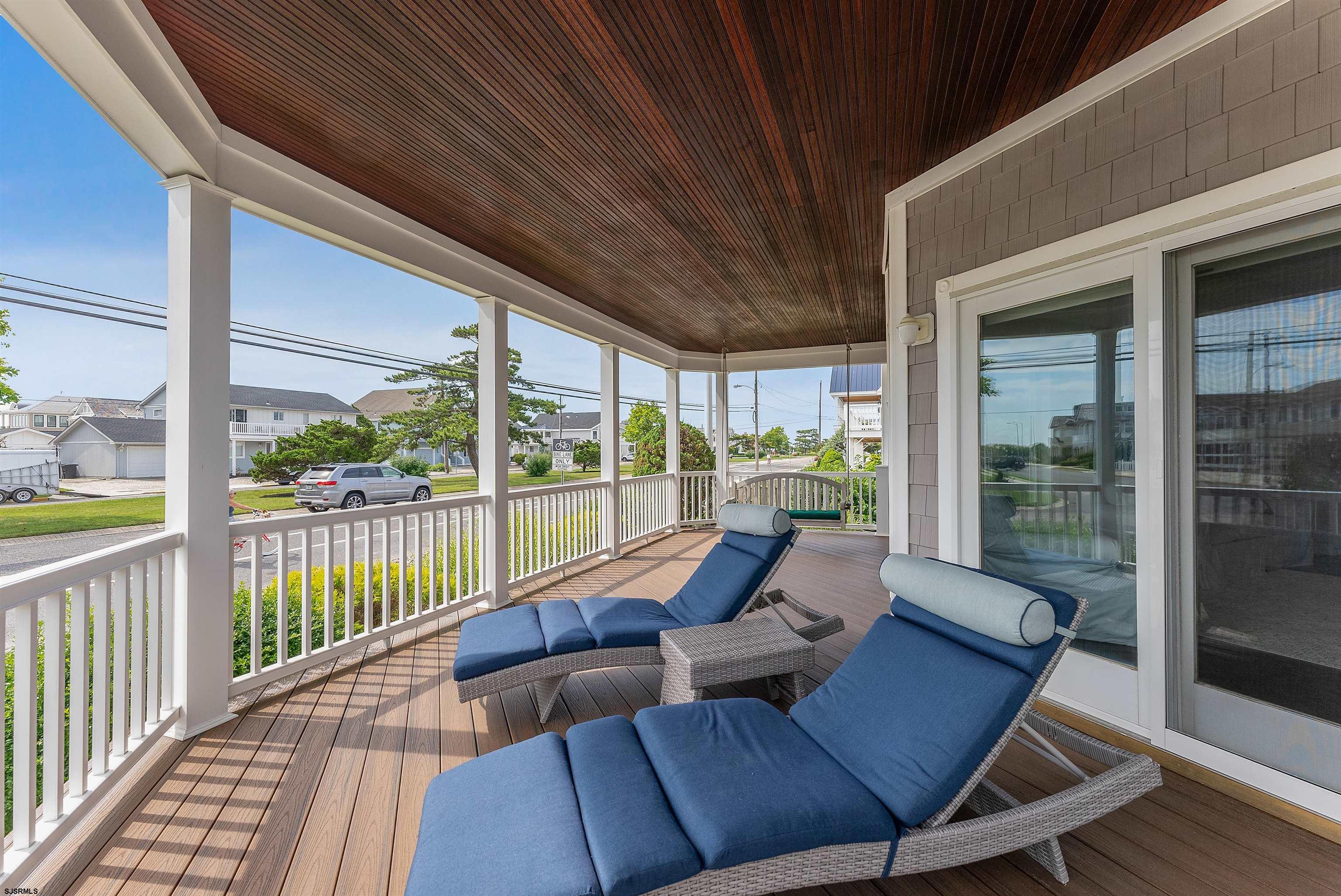 11901 2nd Avenue Stone Harbor, NJ 08247 - Photo 16 of 40 a living room with furniture and a floor to ceiling window