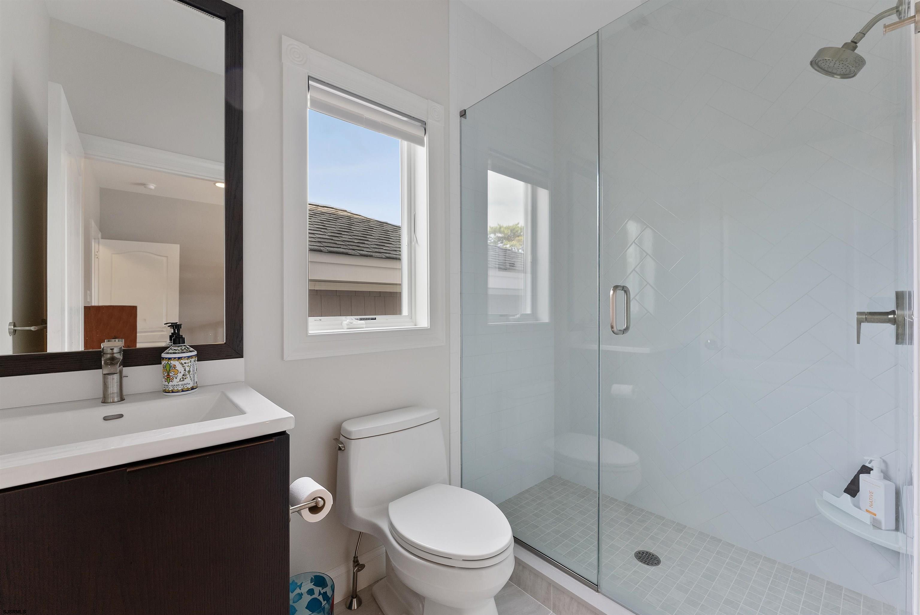 11901 2nd Avenue Stone Harbor, NJ 08247 - Photo 22 of 40 a bathroom with a sink mirror toilet and shower
