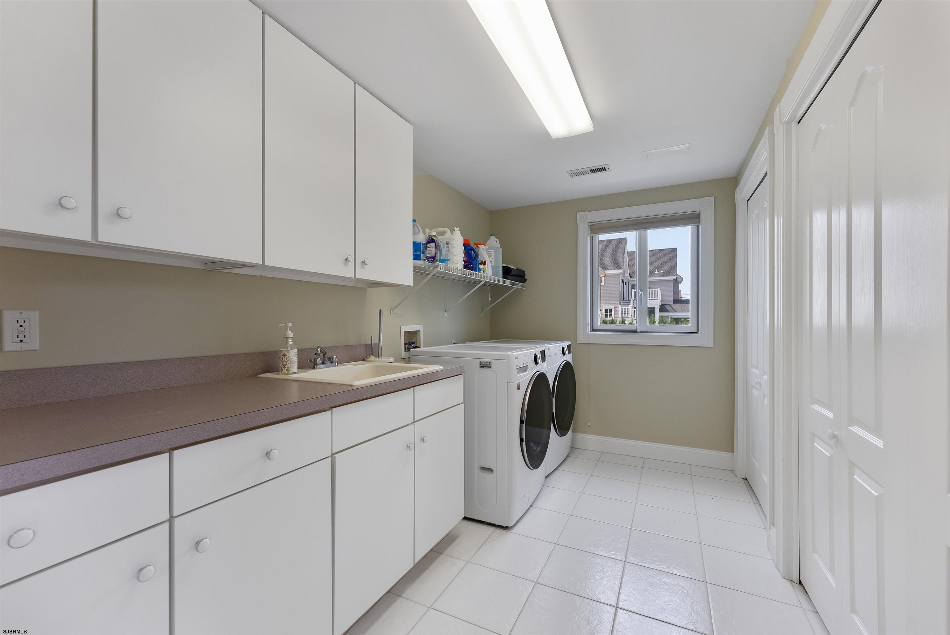 11901 2nd Avenue Stone Harbor, NJ 08247 - Photo 23 of 40 a utility room with cabinets washer and dryer