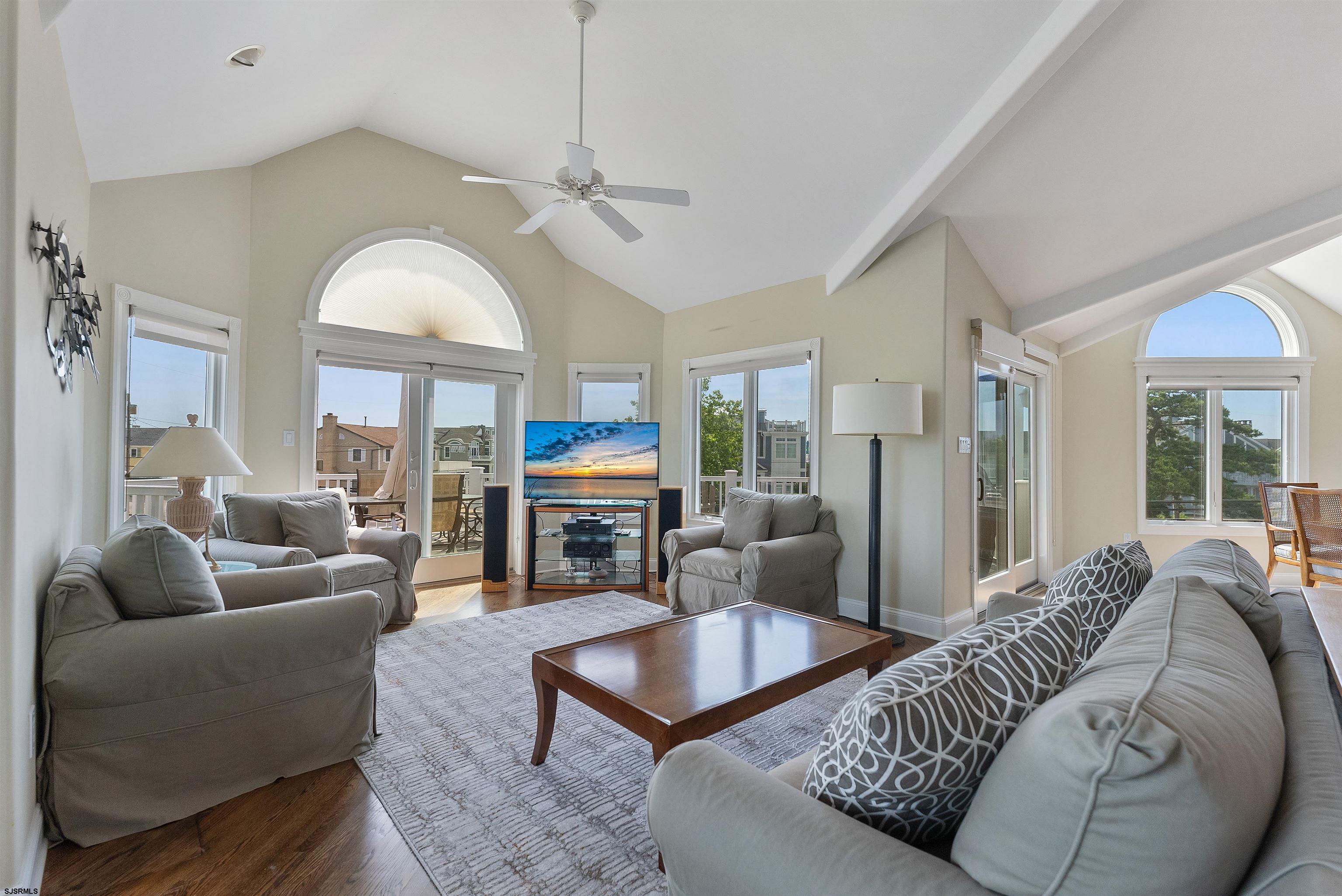 11901 2nd Avenue Stone Harbor, NJ 08247 - Photo 29 of 40 a living room with furniture a fireplace and a large window