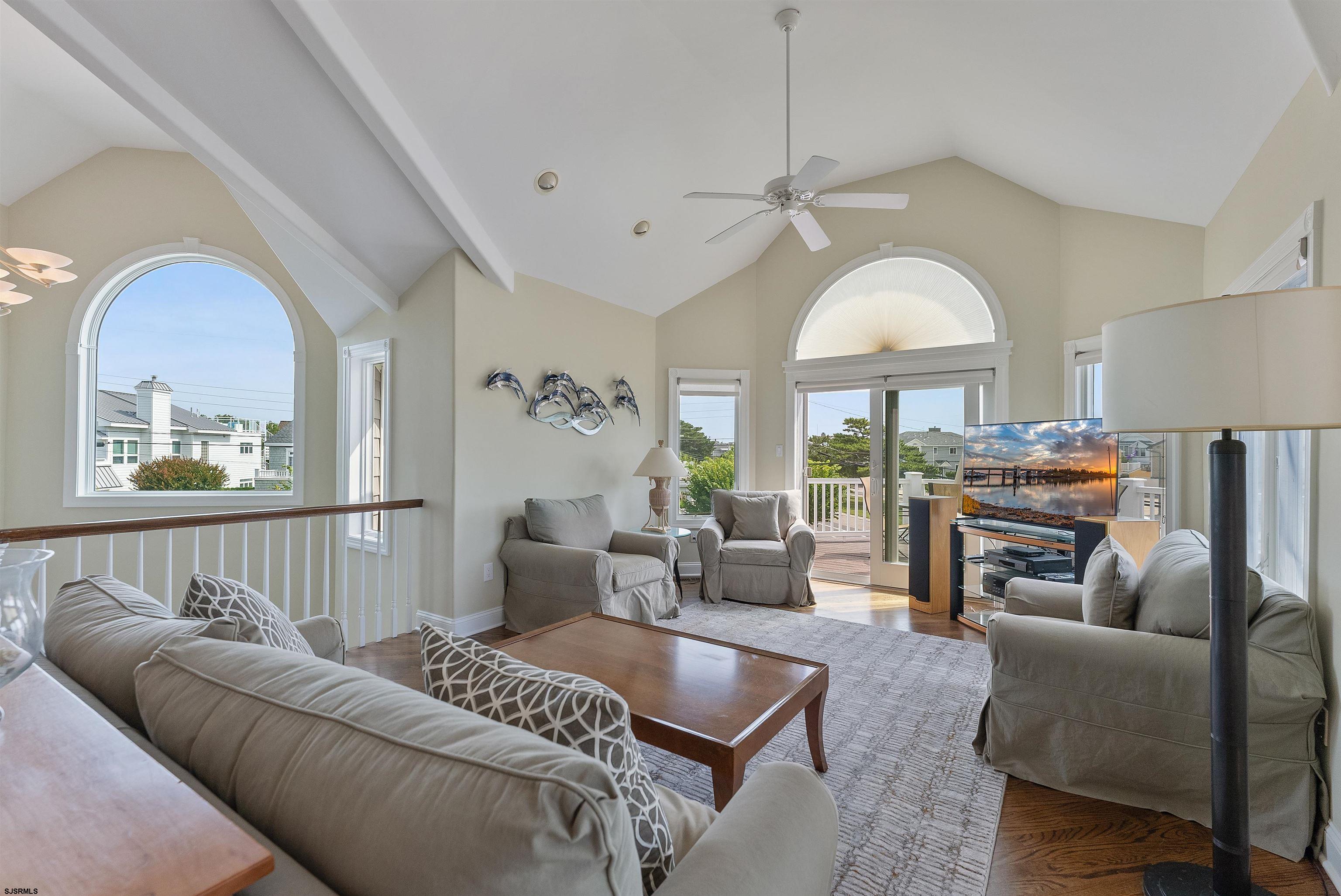 11901 2nd Avenue Stone Harbor, NJ 08247 - Photo 30 of 40 a living room with furniture a fireplace and a chandelier