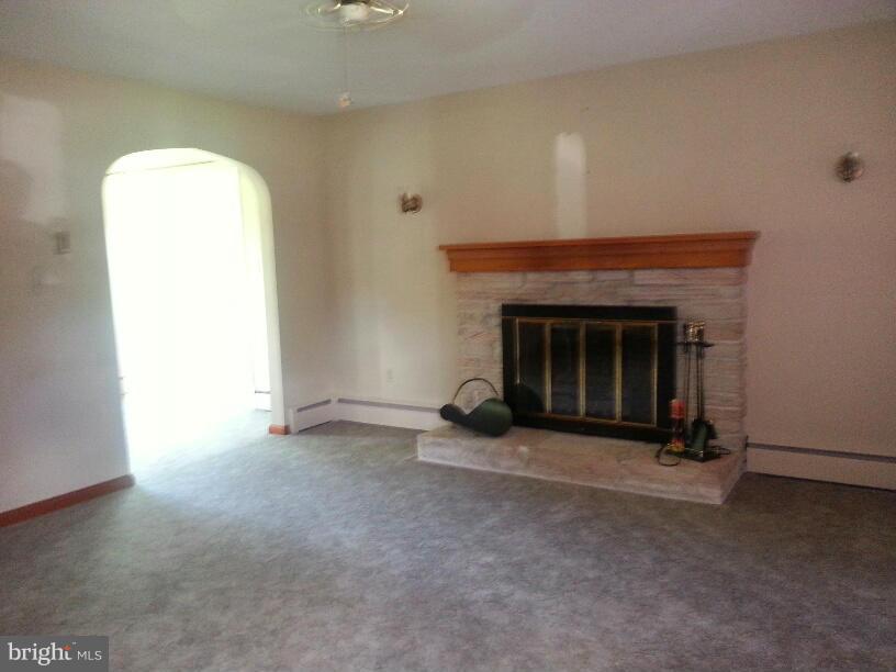11410 Airport Road Waynesboro, PA 17268 - Photo 3 of 14 an empty room with a fireplace