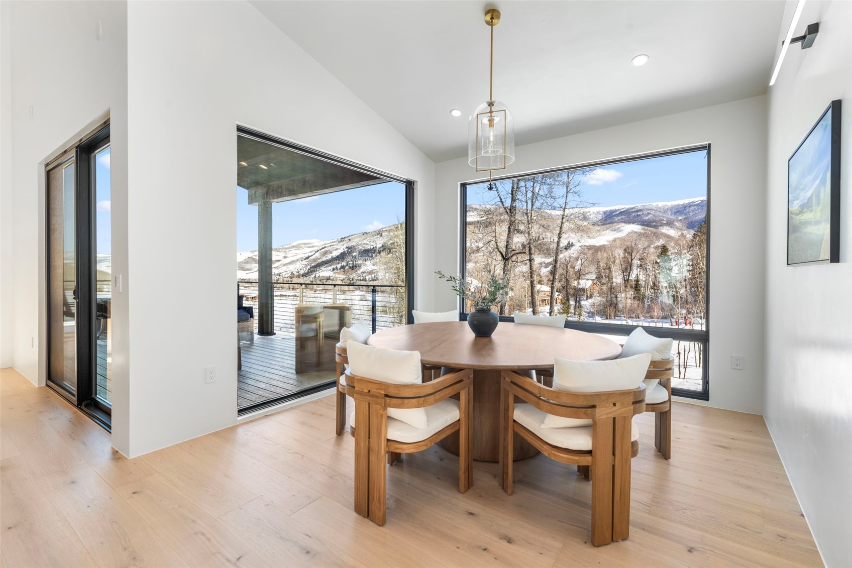 149 Game Trail Road Silverthorne, CO 80498 - Photo 10 of 49 Dining space featuring a mountain view, light wood-type flooring, and lofted ceiling