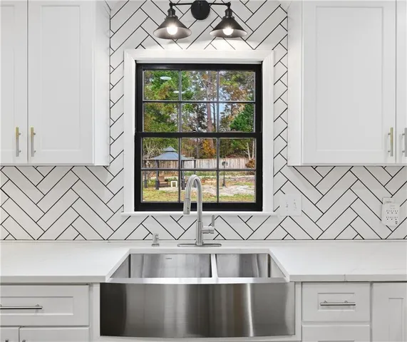 a view of a kitchen with a sink and chandelier