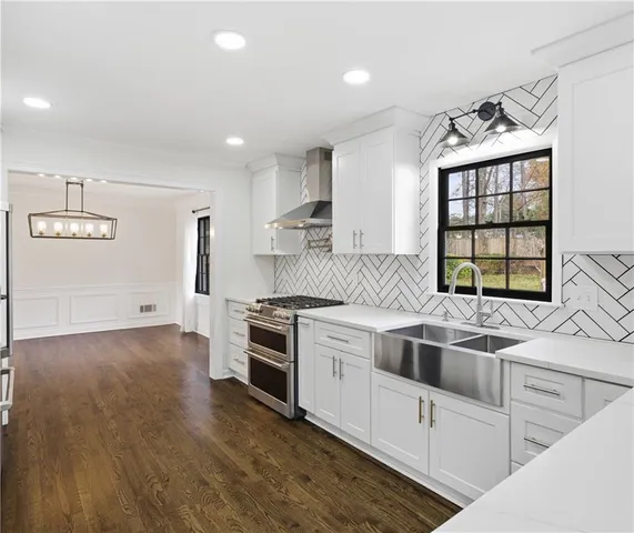 a kitchen that has a sink and a stove