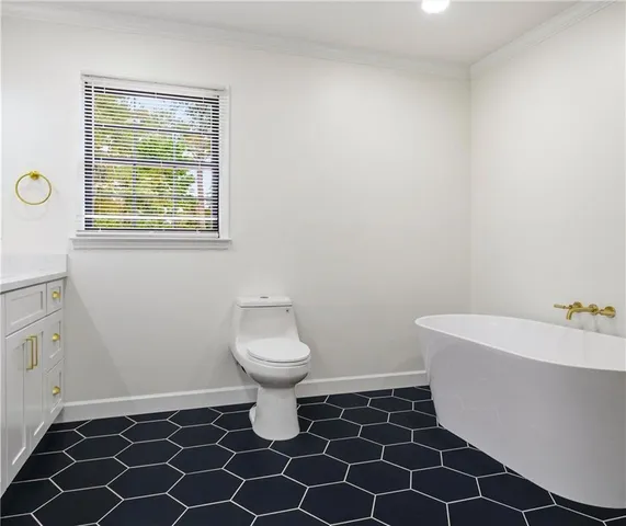 a bathroom with a sink toilet and window