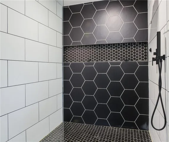 a bathroom with a black white checkered floor