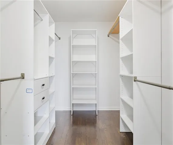 a view of walk in closet with empty racks