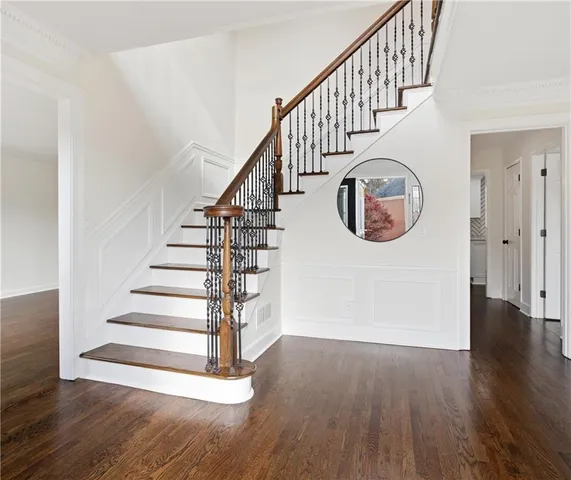 a view of entryway and hall with wooden floor
