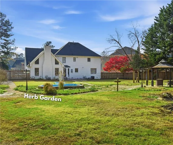 a view of a house with swimming pool and sitting area