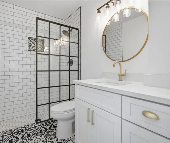 a bathroom with a sink a toilet and a mirror