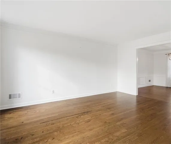 a view of an empty room and wooden floor