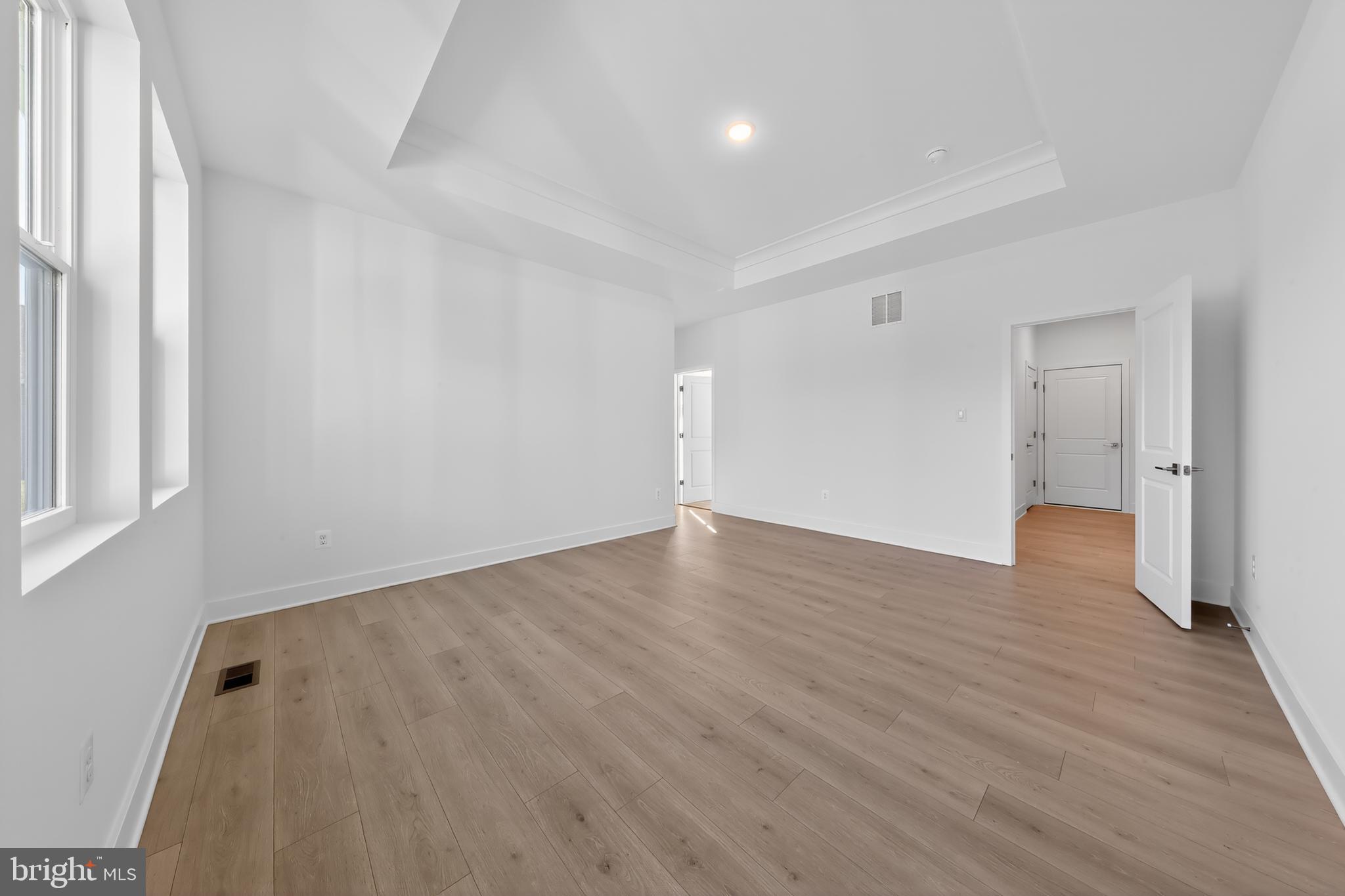 169 North Rdg Brk Drive Felton, DE 19943 - Photo 14 of 24 an empty room with wooden floor and windows