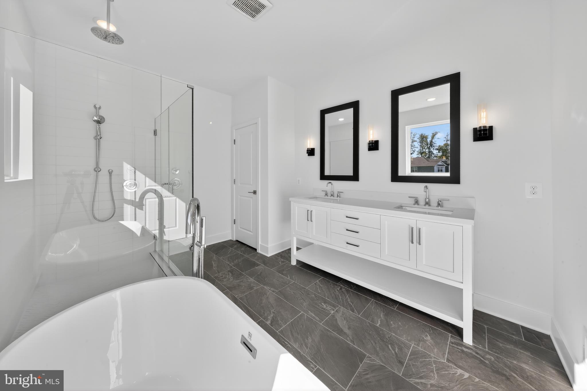 169 North Rdg Brk Drive Felton, DE 19943 - Photo 16 of 24 a spacious bathroom with a double vanity sink a mirror and a bathtub