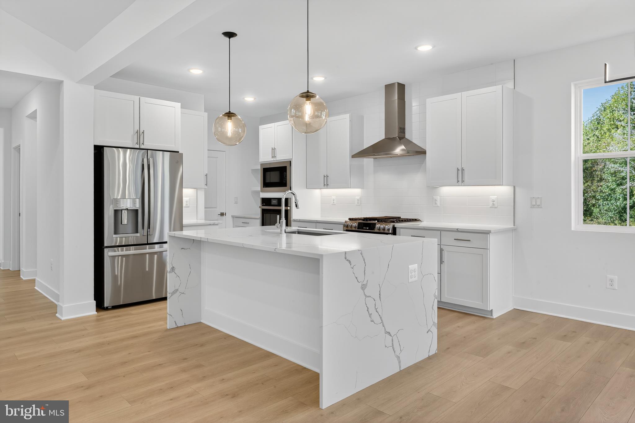169 North Rdg Brk Drive Felton, DE 19943 - Photo 3 of 24 a kitchen with stainless steel appliances granite countertop a refrigerator a stove a sink dishwasher a refrigerator and white cabinets with wooden floor
