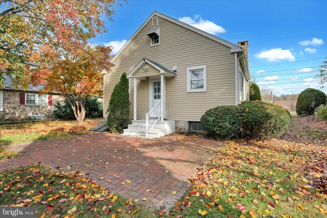 a view of a white house with a yard