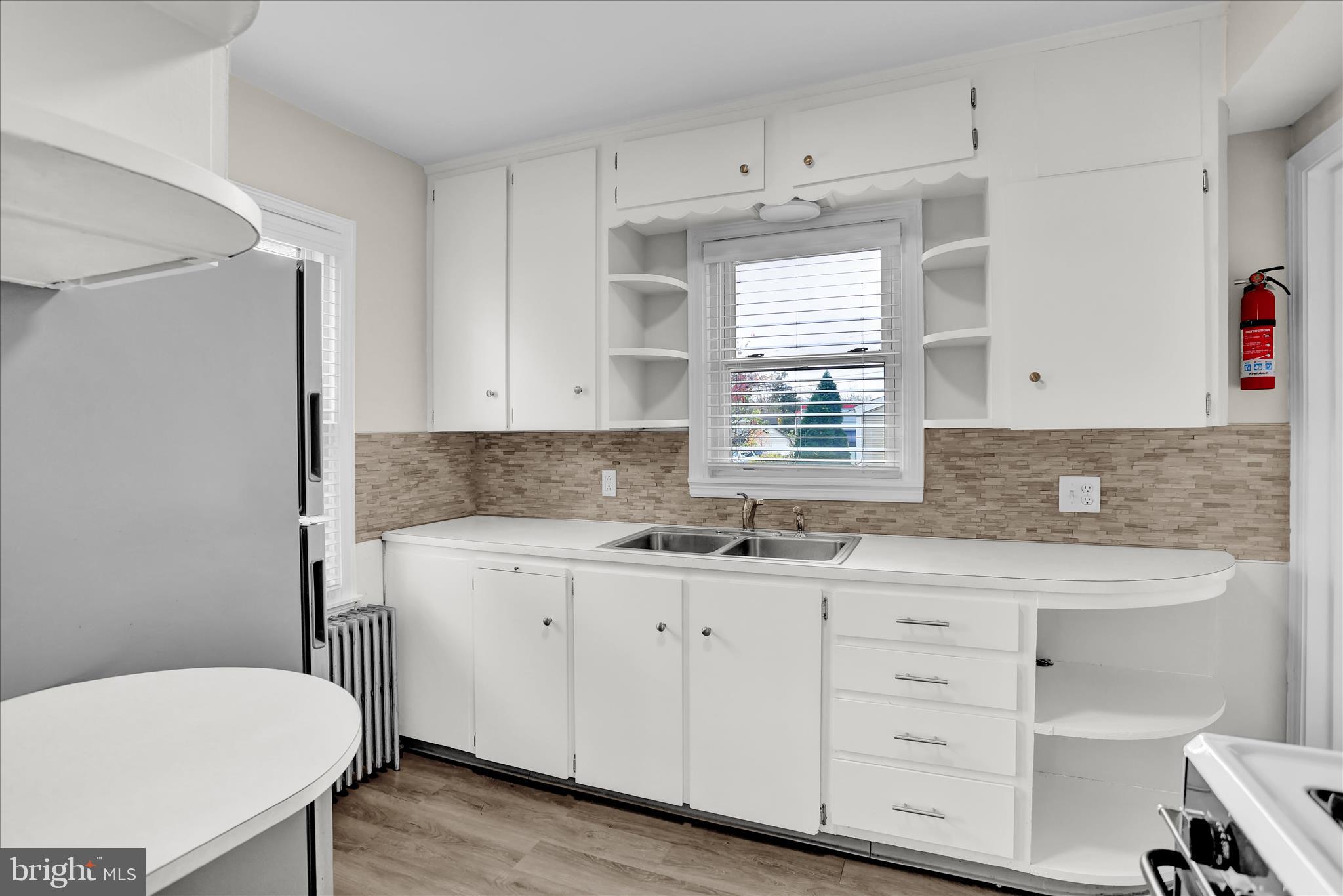 4710 Perkiomen Avenue Reading, PA 19606 - Photo 14 of 39 a kitchen with a sink a stove a refrigerator and white cabinets